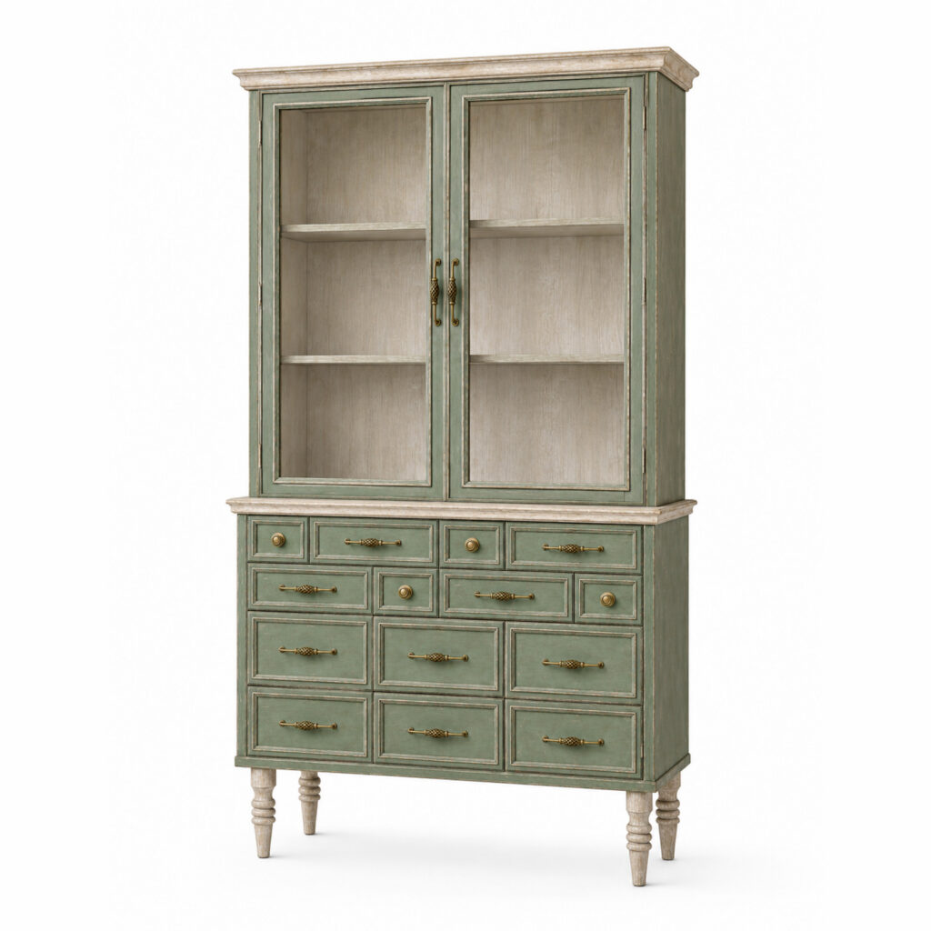 Front view of a tall vintage display cabinet in green and ivory painted wood with an antique finish, two glass doors, multiple drawers, turned legs, and decorative brass handles and knobs on a white background.
