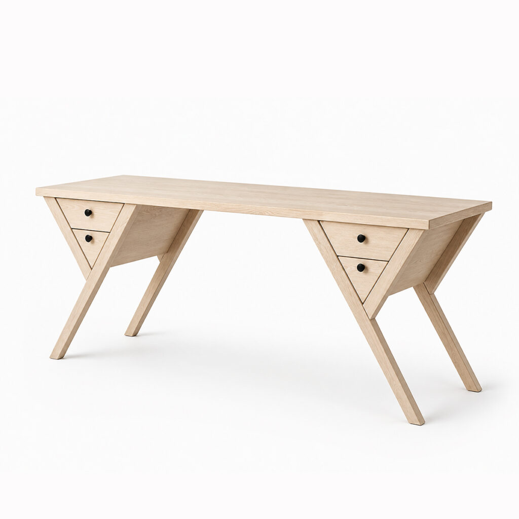 Writing desk in nordic light wood with a wide rectangular top, angled legs, triangular side drawer units and black metal knobs, shown on a white background.